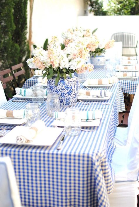 Used as a dramatic centerpiece, this classic porcelain vase gives a sense of formality to the casual gingham tablecloth and mason jar glassware.Via Grace Happens Gingham Tablecloth, Party Tablescapes, Plaid Tablecloth, The Enchanted Home, Baby Shower Brunch, Table Scapes, Enchanted Home, בר מצווה, Pretty Tables