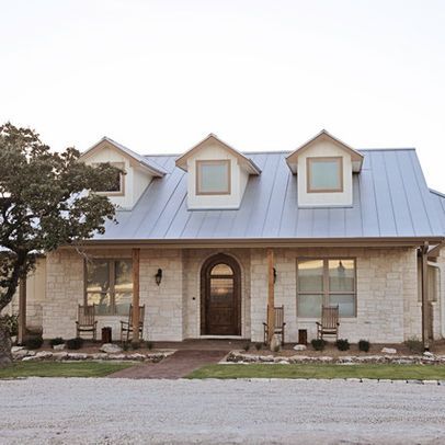 “glass,and limestone veneered walls. The roof is galvalume standing seam with three dormers. It offers a very comfortable and inviting appearance to country living. Rebecca McCoy Photography” “white limestone. It is very common around the Texas Hill Country area. My local supplier is Hill Country Stone (830)895-1366. The sizes are 4, 6, and 8 mix.” “The stone is a chopped white limestone.” Farmhouse Style Exterior, Ranch House Remodel, Exterior House Colors With Stone, Hill Country Homes, Home Exterior Makeover, Exterior Makeover, Traditional Exterior, Exterior Remodel, House With Porch