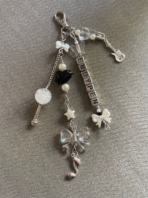 Enhypen inspired keychain with multiple chains, beads, and cute charms! Note: keychains are made to order so there may be some slight bead variations :)