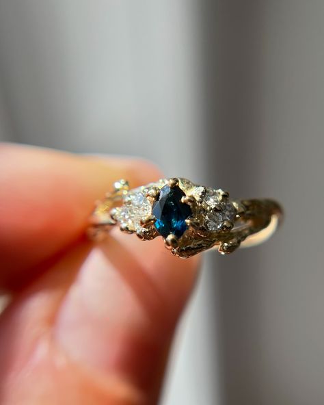 Have you met our new ONE-OF-A-KIND Feyre ring? She has the sweetest marquise cut teal blue sapphire and a cluster of natural diamonds ✨🌌 • • • • • #oliviaewing #oliviaewingjewelry #naturelovers #nature #naturejewelry #branchjewelry #forestjewelry #natureasthetic #cottagecore #cottagestyle #fairytale #fairyaesthetic #fairycore #acotar #feyre #fairylife #acotarjewelry #acourtofthornsandroses #acotafanart #fairytail #fairytale #lotr #lordoftherings #lordoftheringsjewelry #woodlandring #botani... Feyre Ring, Acotar Feyre, Fairytale Engagement Rings, Traditional Engagement Rings, Fairy Aesthetic, Montana Sapphire, Raw Gemstones, Nature Jewelry, Fairy Core