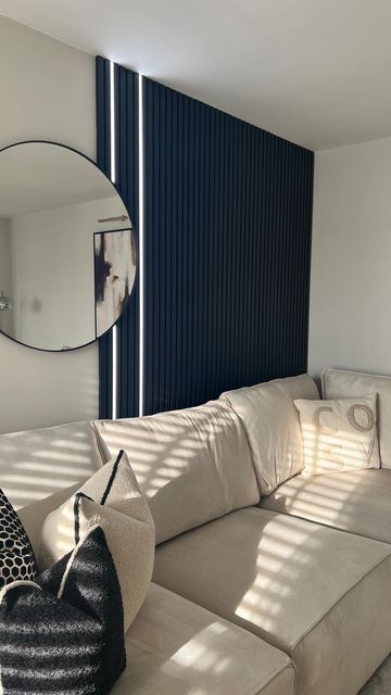 Leah 🧿🤍 on Instagram: "Easy slat panelling with LED lighting 🖤 If you’re not confident enough to try DIY slat panelling then @thewoodveneerhub slat panels are fab. You can now also get LED lighting strips that fit perfectly inbetween the slats. I used 3 acupanel acoustic wall panels in black 240x60cm and 2 acupanel glow LED light strips in cool tone 240cm to create this. Links to both the wall panels and lighting are available in my story highlights plus discount code for any wall panels 🥰 Ad 🏷️ slat panelling | led lighting | monochrome #slatpanelling #ledlighting #livingroominspo #diypanelling #lighting #monochrome #monochromehome #neutralhome #interiordesign #wallpanel #homeinspo #diyhome #scandidecor #minimalstyle" Slat Panelling, Wall Behind Sofa, Deck House, Stripped Wall, Scandi Decor, Wood Slat Wall, Apt Ideas, House Deck, Acoustic Wall Panels