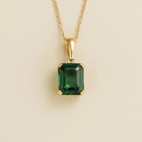 Thamani pendant necklace in 18K gold vermeil set with ~3 carats Emerald. Center stone: 10mm x 8mm emerald cut Pendant dimensions: 17. 4mm height x 8. 4mm width x 6. 3mm depth Length: adjustable 16-18 inches chain Options available in 9K, 14K and 18K gold, and additional sizes, please contact Juvetti. Our precious jewellery is designed to preserve its original brilliance over time. There are a few precautions to make sure to keep your jewellery in the best condition.  Your jewellery should be cle Emerald Cut Pendant, Stone Ring Design, Emerald Set, Gold Bridal Jewellery, Gold Bridal Jewellery Sets, June Birthstone Jewelry, Emerald Pendant, Gold Designs, Emerald Necklace