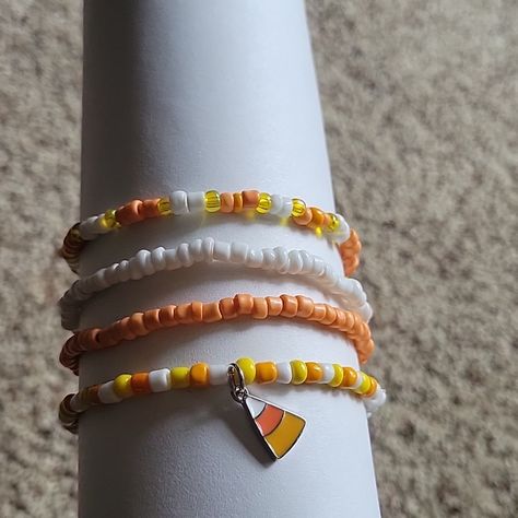 Handmade Halloween Stretch Bracelets. Four Bracelets Total. Colors Are White, Orange And Yellow With A Candy Corn Charm. Beaded Bracelets Fall, Seed Beaded Bracelets, Halloween Beaded Bracelet, Halloween Themed Bracelets, Candy Corn Bracelets, Affordable Halloween Themed Bracelets, Fall Bracelet Ideas, Halloween Bracelet Ideas, Cheap Orange Halloween Bracelets