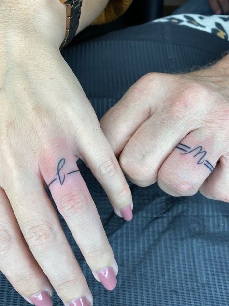 50 Unique Couple Tattoo Ideas For Expression of Love Unique Couple Tattoo, Couple Ring Finger Tattoos, Wedding Ring Finger Tattoos, Marriage Tattoos, Couple Tattoo Ideas, Finger Tattoos For Couples, Ring Tattoo Designs, Wedding Band Tattoo, Tattoo Couple