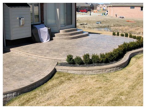 stamped concrete patio designs flowerbed | Patios Gallery 2 - Ruggero Construction (586) 677-8677 Two Level Concrete Patio, 2 Tier Patio Ideas, Kidney Shaped Patio, Two Tier Concrete Patio, Cement Deck Ideas, Tiered Concrete Patio, Concrete Patio With Steps, Patio With Steps, Stamped Patio