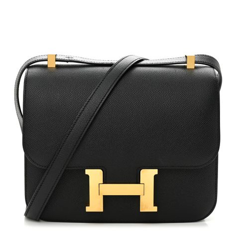 This is an authentic HERMES Epsom Constance 24 in Black. This stylish shoulder bag is finely crafted of epsom calfskin leather in black. The bag features a cross-body strap with gold plated hardware including an H buckle at the front flap. The flap opens to a compact partitioned black leather interior with flat and zippered pockets. Hermes Constance Bag, Hermes Purse, Stylish Shoulder Bag, Hermes Constance, Hermes Handbags, Hermes Bags, Leather Interior, Calf Skin, Dust Bag