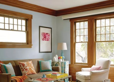 If you live in a house that was built or renovated between the early 1990s and 2000s, you likely have the infamous orange oak trim that many homeowners have since painted over. It's a home decor controversy that's been debated for years—some homeowners despise the warm trim in their homes while others wouldn't dream of painting over the wood.    However, warm wood tones seem to be more popular recently than years prior. What does this mean for those who are itching to paint over their oak trim? Sh Paint Oak Trim, Trim Living Room, Installing Wainscoting, Oak Trim, Decorating Advice, Small Space Diy, Room Remodeling, Crown Molding, Home Trends