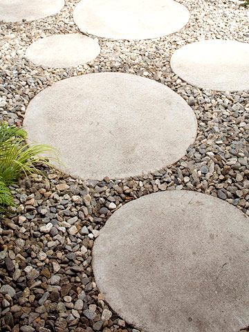 Concrete steppers laid in gravel create a cute pathway that connects the outdoor room to the back of the house. By covering the yard with gravel, the homeowner has very little yard maintenance to deal with, giving him more time to enjoy the fruits of his labor. Colored Cement, Inspiring Gardens, Green Gardens, River Pebbles, Yard Maintenance, Gravel Path, Outdoor Room, Garden Pathway, Paving Stones