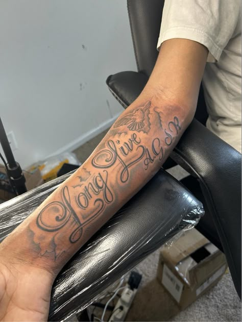 Forearm Tattoo Men Name, Medium Size Forearm Tattoo Men, Hand Text Tattoo, Long Live Tattoos, My Brothers Keeper Tattoo Ideas, Text Tattoo Arm, Forearm Tattoos For Guys, Long Live Tattoo Black People, Name Tattoos For Men