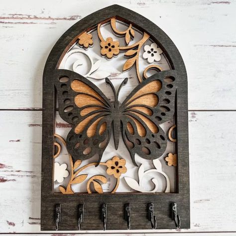 This butterfly wall key holder is a unique and functional home accent that will add a touch of whimsy to any space. Made from solid wood and hand-painted in a vibrant rainbow of colors, this key holder is sure to turn heads. It's also a great way to keep your keys organized and within.#laserkeyholder #keyorganization #customkeyholder #keyaccessories #keyholderdesign Laser Cut Gift Ideas, Key Holder Wall, Wooden Key Holder, Laser Cut Wood Crafts, Butterfly Motif, Laser Art, Functional Home, Wall Key Holder, Key Hanger