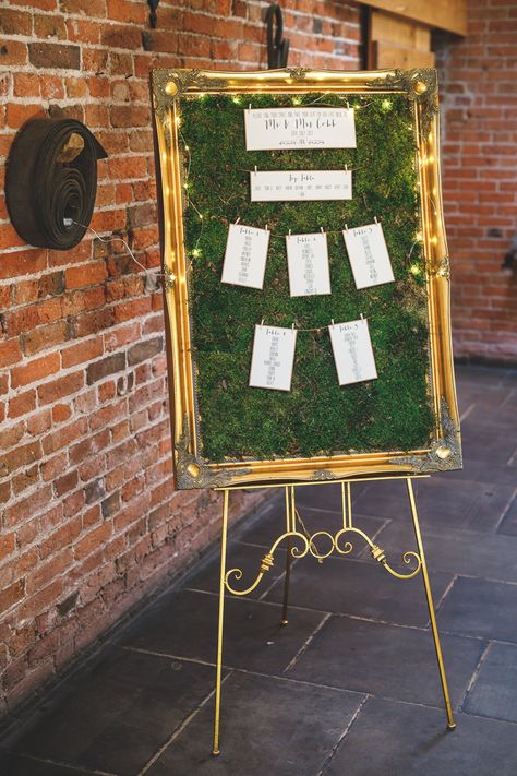 Table Plan Seating Chart Gold Frame Fairy Lights Moss Rustic Barn Red Gold Glam Wedding https://garethnewsteadphotography.com/ Moss Seating Chart, Fall Wedding Seating Chart, Wedding Sitting Plan, Auction Decorations, Moss Sign, Garden Table Numbers, Fall Wedding Seating, Moss Table, Wedding Table Garland