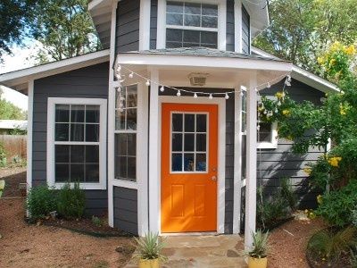 Grey House White Trim, Lake House Paint Colors, Dark Grey Houses, Orange Front Doors, Austin Vacation, Gray House Exterior, White Shutters, Orange Door, Gray House