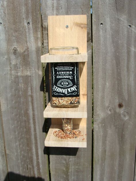 Looking for ways to repurpose those empty liquor bottles you have hanging around? These Jack Daniel's DIY projects are for you. In college, a group of my friends decorated the “dining room-kitchen-foyer” area of their dorm with 15 vodka bottles (1.75�… Whiskey Bottle Crafts, Empty Liquor Bottles, Bottle Bird Feeder, Alcohol Bottle Crafts, Jack Daniels Bottle, Liquor Bottle Crafts, Alcohol Bottles, Jack Daniels Whiskey, Bird Seed