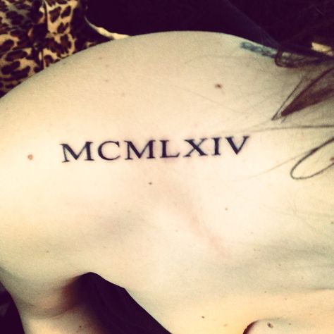 "1964" Roman numerals on the shoulder tattoo On The Shoulder Tattoo, 1964 Tattoo, Tattoos Roman Numerals, Tattoo Roman Numeral, The Shoulder Tattoo, Roman Numeral Tattoos, Skeleton Hand Tattoo, Shoulder Tattoos, Cute Piercings