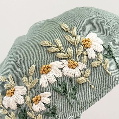 Hand Embroidery by Gaby ✨ on Instagram: "It's a sage green kinda day! ☺️🌸🌿 and my favorite flowers to stitch 😍 New hats are coming to the shop this Saturday at 5pm! #modernembroidery #embroideredhats #sagegreen #embroideredflowers #hatday #summeroutfitinspo #etsycreatorco" Hat Hand Embroidery, Sage Embroidery, Sage Cottage, Needlework Ideas, Hat Day, Hat Embroidery, Favorite Flowers, Modern Embroidery, Embroidered Hats