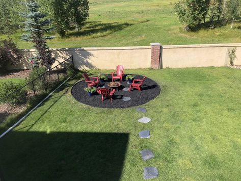 Made it with rubber mulch. For 9 months of the year it is a fire pit and for our short summer it has our pool on it. Fire Pit With Mulch, Rubber Mulch Fire Pit Area, Rubber Mulch Patio, Mulch Fire Pit Area, Backyard Goals, Rubber Mulch, Elegant Entryway, Fire Pit Landscaping, Fire Pit Area