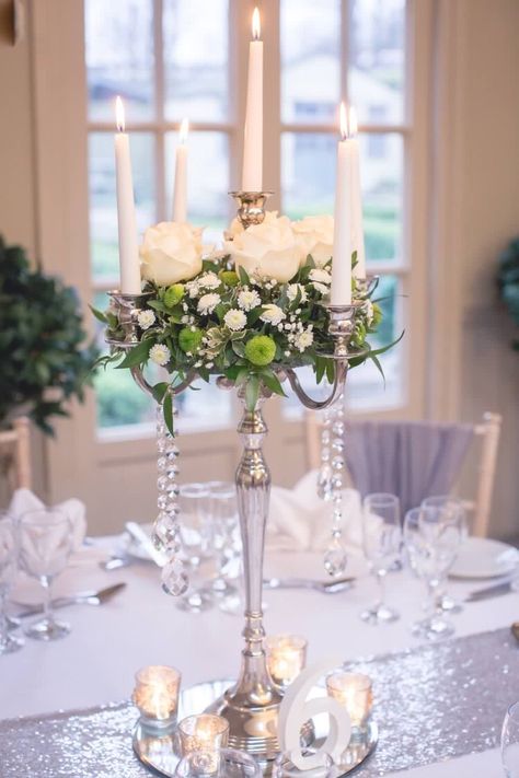 Candelabras on mirror base and tea light holders at The Parlour at Blagdon in Northumberland. Wedding styling and decorations available to hire from The Artisan Wedding House Wedding Candelabra Flowers, Silver Candleabra Centerpiece Wedding, Gold Candleabra Centrepiece, Tea Lights Centerpieces, Candelabra Wedding Centerpieces, Candelabra Wedding, Christmas Floral Arrangements, Christmas Floral, Home Wedding