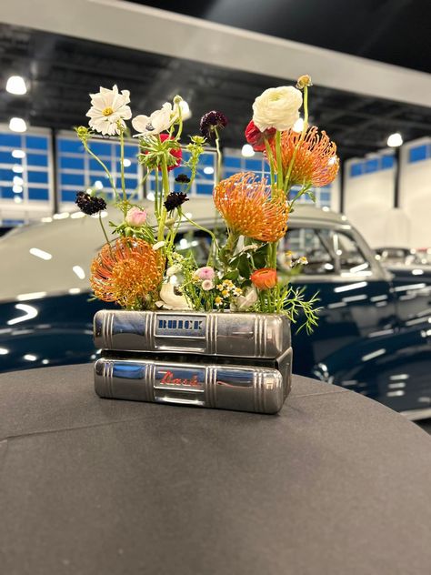 I loved this job so much! Another reminder that fresh flowers are my absolute favorite thing to do. These arrangements were for a birthday party held at an antique car museum. I was not only able to use my creativity with the flowers, I was able to dig through rooms of vintage car parts for these arrangements. What a remarkable experience. These arrangements are in tissue holders in the 50’s. I also used a variety of ashtrays and wheel covers. Sterner's Stems Melissa Sterner #classicc... Gala Centerpieces, Vintage Car Decor, Vintage Car Party, Car Museum, Wheel Cover, Car Decor, Fresh Flowers, Vintage Cars, Antique Cars