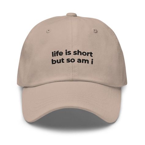 Introducing our "Life Is Short But So Am I" Baseball Cap - the perfect fit for those who embrace their vertically challenged stature with a smile! Short in height but tall in spirit? This cap is made for you. Crafted with comfort and humor in mind, it's the ideal accessory to add a little fun to your everyday look.   - Made of chino cotton twill - Unstructured, 6-panel, low-profile - 6 embroidered eyelets - 3 ⅛" (7.6 cm) crown - Adjustable strap with antique buckle Cute Hats Aesthetic, Cheap Funny Baseball Cap With Curved Brim, Funny Baseball Hats, Funny Caps Hat, Funny Streetwear Hats, Funny Baseball Hat, Embroidered Ideas, Funny Baseball Caps, Baseball Hats For Women