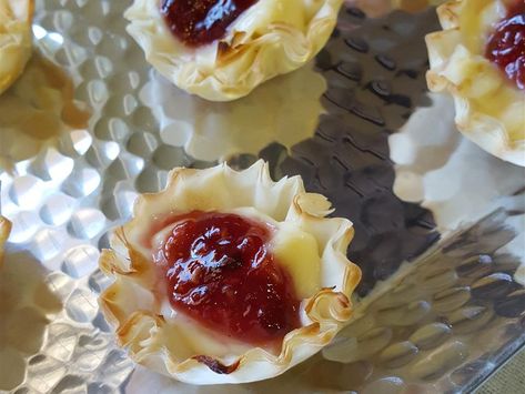 These brie phyllo cups are topped with raspberry preserves, then baked in the oven for a quick, easy, and sophisticated bite-sized, cheesy appetizer. Brie Phyllo Cups, Brie Cups, Pear Tartlets, Blue Cheese And Pear, Brie Phyllo, Phyllo Appetizers, Raspberry Brie, Phyllo Bites, Puff Pastry Recipes Appetizers