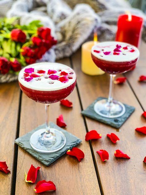 Love Potion #9, the perfect Valentine’s Day cocktail. Our take on a gin sour, the cocktail has gin, lemon juice, simple syrup, pomegranate juice and rose petals. It will make that date night or vday date super special. #romantic #cocktails #cocktailrecipes #cocktaildrinks #cocktailarts #valentines #valentinesday #valentinesdayideas #valentinesdayparty #valentinesdayfood #datenightmenu #datenightideas #gincocktails Valentines Cocktails Drink Recipes, Pomegranate Gin, Romantic Cocktails, Valentine Drinks, Valentine Cocktails, Gin Sour, Gin Lemon, Valentines Day Food, Champagne Cocktail