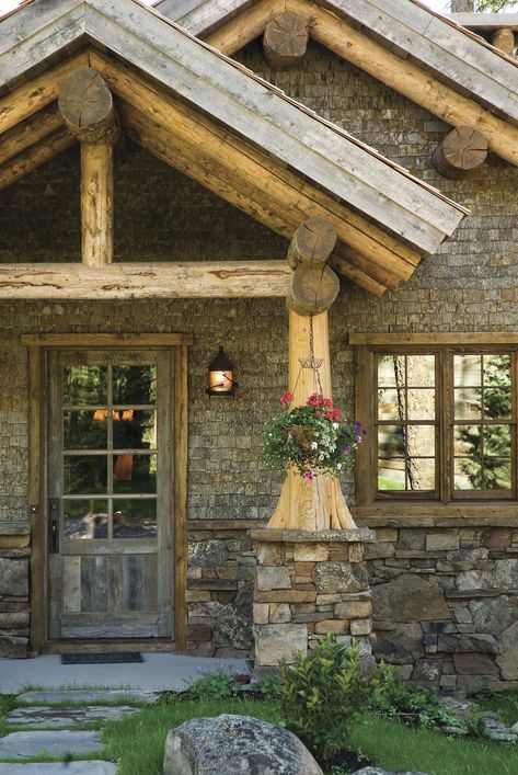 Big Sky Journal - Lichen covers the rock wainscoting and reclaimed cedar shake siding in the entryway, giving visitors the feeling that this new cabin has been around for decades. Rock And Log Homes Exterior, Rock Wainscoting Exterior, Cedar Shake Cabin, Updating A Log Cabin Exterior, Log Cabin With Stone Exterior, Woodtone Rustic Siding, Log Home Chinking Exterior, Cedar Shake Siding, Cabin Doors