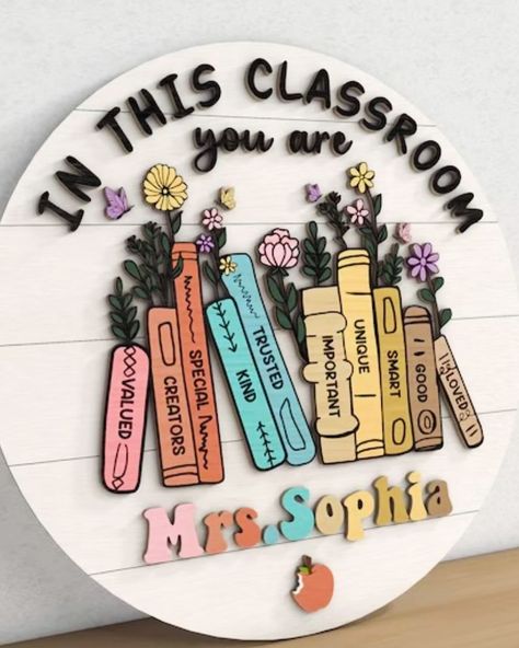 This teacher name sign is perfect with its inspirational 3D words & floral books. 📚 This sign is amazing for the classroom! 🏫 Personalize it here! 🔗 https://kaitlynroseco.com/products/teacher-name-sign-inspirational-floral-books . . #teachersign #teacherdoorsign #teacherdoorhangers #teacherlife #teachergifts #3ddoorsign #lasercut #lasercutting #laserengraving #laserengraved #shopsmall #shoplocal #shophandmade #mamaownedbusiness Classroom Signs Wooden, Classroom Door Signs Teacher Name Diy, Cute Door Decorations Classroom, Diy Teacher Sign, Aesthetic Classroom Decor, Teacher Symbol, Teachers Day Decoration, Teacher Classroom Sign, Classroom Door Displays