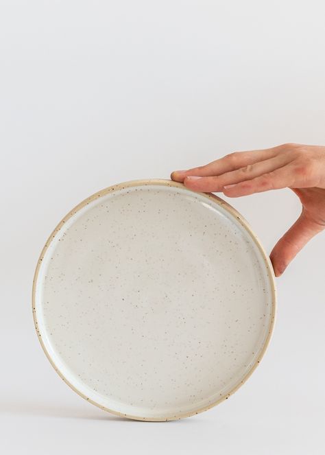 Minimal ceramic plates with a rim / edge made with fantastic speckled clay and white glossy food-safe glaze inside. Plates have minimal modern design and bright, calm look.  If you are interested in greater amount - please use this listing https://www.etsy.com/listing/1283221815/minimal-ceramic-plates-with-a-rim Plates are available in two sizes. Approx. measures  dinner size Ø = 9.4''/24 cm height = 0.8''/2cm smaller / breakfast size Ø = 7.8''/20 cm height = 0.8''/2cm Microwave and dishwasher safe. Food-safe glaze. Handmade wheel-thrown pottery. You can also complete this dinnerware with matching bowls and cups.  Plates are made on pottery wheel with fantastic spotted clay, white glossy glaze inside. The outside surface is clear unglazed speckled clay, fantastic in touch.  Feel free to as Natural Dinnerware, Earthy Ceramics, Minimal Modern Design, Speckled Clay, Wine Coasters, Handmade Plates, Stoneware Dinnerware, Wheel Thrown Pottery, Ceramic Dinnerware