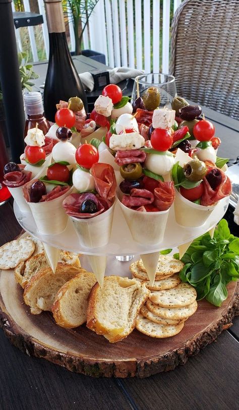 a gorgeous stand with bread and crackers, with charcuterie cones of salami, olives, ham, cheese and pickled vegetables is perfect for any wedding or party Wedding Appetizers, Charcuterie Inspiration, Charcuterie And Cheese Board, Charcuterie Recipes, Snacks Für Party, Food Display, Halloween Snacks, Party Food Appetizers, Charcuterie Boards