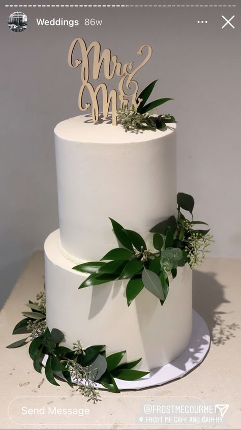 Wedding Cake With Foliage, White Cake With Green Leaves, 2 Tier White Wedding Cake With Greenery, Emerald Green Wedding Cake Simple, White Cake With Eucalyptus Leaves, Simple Green Wedding Cake, Wedding Cake Sage Green, Wedding Cake Olive Leaves, Fern Cake