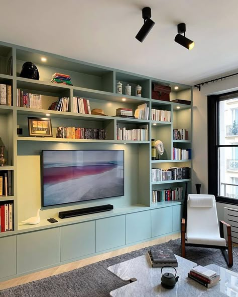 On the other hand, this design has downlights installed on each shelf and contains track lights on the ceiling. Image credit: INSTAGRAM @ADVANESSAFAIVRE Reading Room Design, Bookshelves With Tv, Built In Shelves Living Room, Living Room Wall Units, Living Room Built Ins, Built In Cabinet, Living Room Shelves, Small Home Office, Built In Bookcase