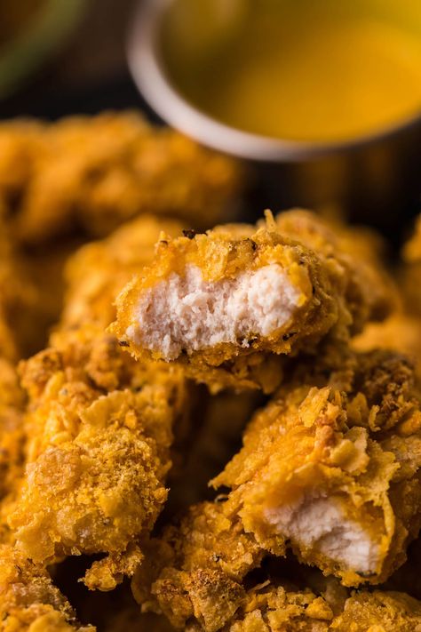 captain crunch chicken fingers in a pile and being dipped in honey mustard dip. Homemade Breaded Chicken, Air Fryer Breaded Chicken Breast, Captain Crunch Chicken, Captain Crunch Cereal, Captain Crunch, Breaded Chicken Breast, Crunch Cereal, Planet Hollywood, Chicken Fingers