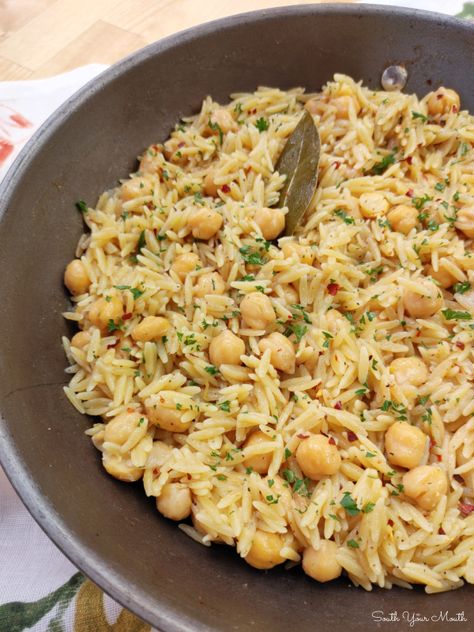 Spicy Chickpeas with Orzo! A Mediterranean inspired recipe with chickpeas (garbanzo beans), orzo and layers of spices and mild heat that doubles as the perfect side or a meatless main dish. Orzo And Chickpeas, Spicy Orzo Recipes, Recipes With Garbanzo Beans, Garbanzo Recipes, Recipe With Chickpeas, Vegan Rice Dishes, Garbanzo Bean Recipes, Spicy Chickpeas, Greek Potatoes