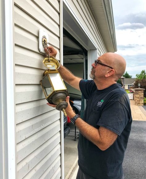 Hubby taking off outdoor light fixture Outside Light Fixtures, Outdoor Garage Lights, Outdoor Light Fixture, Outdoor Porch Lights, Outside Light, Painting Shutters, Orange Door, Front Door Makeover, Rub N Buff