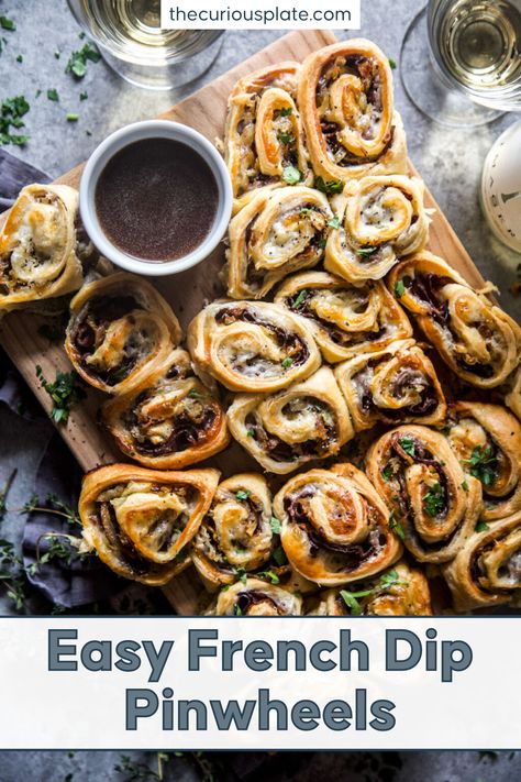 These Easy French Dip Pinwheels are made of layers of deli roast beef, melty provolone cheese, and sweet caramelized onions rolled in buttery dough and baked to crisp, golden goodness! It comes with homemade au jus, a French savory beef gravy to dip the yummy pinwheels into. These easy and delicious morsels make the perfect party appetizers or all-day snacks for the family. Pop over to my site for the recipe! | appetizers | easy snacks | pinwheel appetizers | French Bread Dip Appetizers, Pot Roast Appetizer, French Dip Roll Ups, Super Simple Appetizers, What To Serve At A Party, Best Meat Appetizers, Easy Festive Appetizers, Beef Appetizers Fancy, Crescent Roll Appetizers Christmas