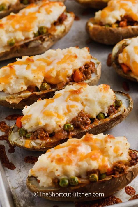 Savor the goodness of cottage pie baked potatoes - a match made in heaven combining twice baked potatoes with shepherd’s pie! Baked potato shells are filled with a savory ground beef hamburger mixture, your chosen veggies, and finished with cheesy mashed potatoes. This hearty version of twice baked potatoes is not only delicious but also a breeze to make. #theshortkcutkitchen #cottagepiebakedpotatoes #cottagepiestuffedbakedpotatoes #cottagepietwicebakedpotatoesrecipe Shepherds Pie Twice Baked Potatoes, Twice Baked Shepards Pie Potatoes, Shepards Pie Stuffed Potatoes, Shepherds Pie Stuffed Potatoes, Cottage Pie Baked Potato Recipe, Stuffed Potatoes With Ground Beef, Cottage Pie Baked Potato, Steak And Baked Potato, Potato Party