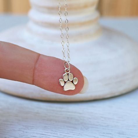 "Wear this adorable Paw Print Necklace to honor the love of your pet who provides unconditional love and endless enjoyment to your life! A perfect gift for any dog or cat lover. Add a birthstone charm to your paw print necklace to make it extra special (see the link below for this option). DETAILS * Sterling Silver Paw Print Charm measures: (13.5mm x 9.5mm) x (0.53\" x (0.37\"). * Charm height includes 5mm jump ring. * Paw Print Charm is marked 925. * 925 Sterling Silver Cable Chain and all Comp Dog Jewelry For People, Paw Template, Cat Paw Necklace, Dog Paw Jewelry, Tiny Paw Print, Paw Print Pendant, Paw Jewelry, Dog Lover Jewelry, Paw Necklace