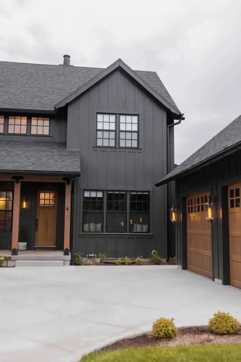 Black Siding Farmhouse Exterior, Black Siding Wood Accents, Wood Tone House Interior, Grey House Black Trim Wood Accents, Dark Cabin Exterior Colors, Dark House Paint Colors, Black House Ideas Exterior Paint, Dark Brown House With Black Trim, New Farmhouse Exterior