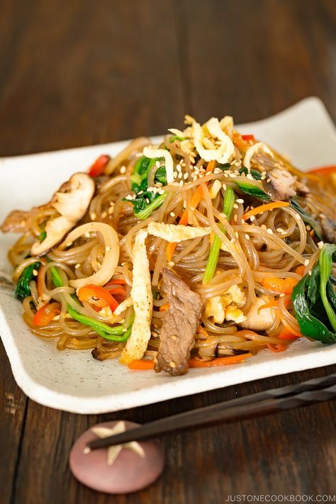 Have you tried Japchae, or Korean Stir-Fried Noodles? Chewy sweet potato glass noodles (dangmyeon) are juxtaposed with colorful stir-fried vegetables and meat and finished in a sweet and savory sauce. This recipe will show you how easy it is to cook up this beloved Korean noodle dish at home! {Vegetarian adaptable} | Easy Japanese Recipes at JustOneCookbook.com Japchae Recipe Korean, Sweet Potato Glass Noodles, Potato Glass Noodles, Japchae Noodles, Korean Noodle Dishes, Glass Noodles Recipe, Korean Glass Noodles, Ramen Seasoning, Korean Sweet Potato