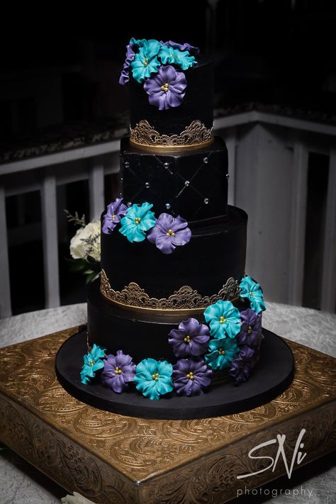 Black and gold buttercream wedding cake with blue and purple sugar flowers by Party Flavors Custom Cakes. Wedding Cake Blue Gold, Super Torte, Purple Wedding Cake, Galaxy Wedding, E Juice, Purple Wedding Cakes, Black Wedding Cakes, Dream Wedding Cake, Wedding Cake Flavors