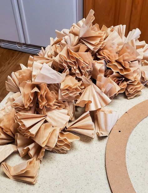 These days, you can create a wreath with anything! Paper coffee filters are no exception!I've see pretty wreaths like this in boutique shops and such. I loved them; but not the price! I figured I could easily make something similar, and much more cost effective! Below, I'm going to show you how to make one in just a few easy steps! Supplies You will need a wreath form of your choice, coffee filters, and a hot glue gun.I used a cardboard wreath, I found at the Goodwill; along with free… Cardboard Wreath, Cardboard Wreath Form, Penny Ball, Brown Wreath, Concrete Bird Bath, Coffee Filter Wreath, Twig Lights, Straw Wreath, Coffee Filter Crafts