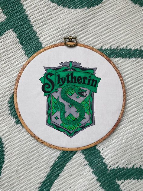 Slytherin crest embroidery hoop Slytherin Embroidery, Slytherin Embroidery Pattern, Slytherin Cross Stitch Pattern, Hogwarts Embroidery, Harry Potter Embroidery Patterns Free, Hp Embroidery, Slytherin Crest, Simple Embroidery Designs, Simple Embroidery