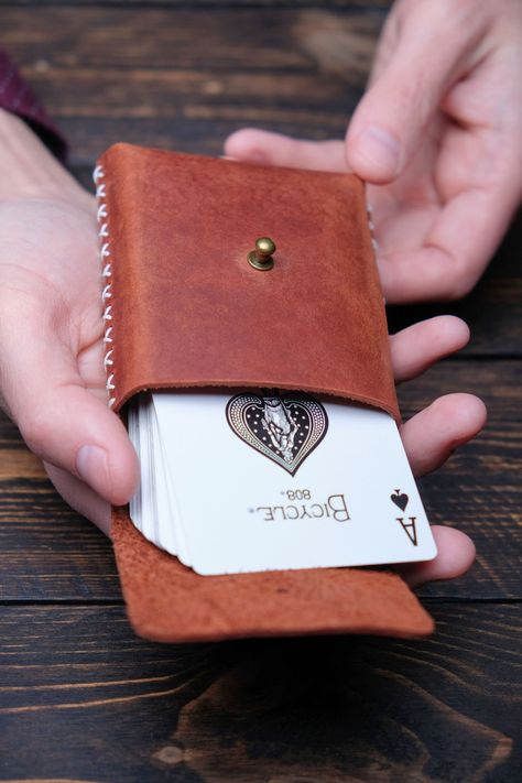 "A gorgeous gift for your loved one who loves to play cards. Genuine leather, it is always comfort and a chic look. Your deck of cards will be reliably protected! ♤ Handmade Personalized Playing Cards Holder. ♧ Perfect for poker decks or regular cards. ♢ Best gift for poker player. ♡ Helps to keep your cards in order. ♠️ Details: *100% handmade. *Durable full-grain leather. *Hand stitching with waxed thread. *Hight quality fittings. ♣️ Sizes: Length: 4,1in (10.5cm) Width: 3in (7.5cm) Height: 1in Leather Working Projects Ideas, Art Du Cuir, Playing Card Case, Diy En Cuir, Leather Working Projects, Personalized Playing Cards, Leather Goodies, Playing Card Holder, Diy Leather Projects