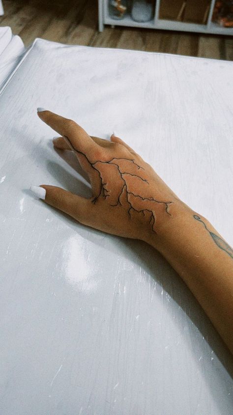 250+ Lightning Tattoos Ideas and Designs (2023) - TattoosBoyGirl Lightning On Hand Tattoo, Lightning Tattoo Men Hand, Hand Lighting Tattoo, Hand Tattoos Lightning Bolt, Hand Tattoos For Women Lightning, Lightening Hand Tattoos, Lighting Tattoo Arm Sleeve, Lighting On Hand Tattoo, Lightening Bolt Hand Tattoo