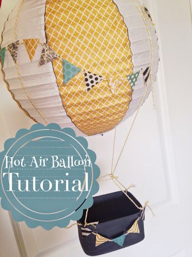 These cute hot air balloons are made using a paper lantern, scrap book paper, chip wood boxes and string Hot Air Balloon Decoration, Air Balloon Decoration, Theme Bapteme, Diy Hot Air Balloons, Hot Air Balloon Party, Hot Air Balloon Decorations, Ornament Tutorial, Baby Shower Balloons, Paper Lanterns