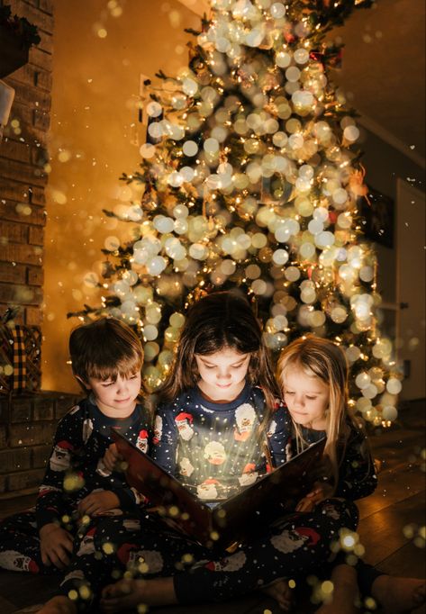 Settings 24-70 2.8 at 24mm and f/2.8. Shutter 1/60, ISO 1/1250. Used phone for light + overlays for tree, background and book. #christmasphotography Kids Pictures Under The Christmas Tree, Christmas Book Picture With Light, Kids In Front Of Christmas Tree Pictures, Siblings Xmas Photo Ideas, Kids Christmas Tree Pictures, Sibling Christmas Tree Pictures, Siblings Christmas Photoshoot Ideas, 3 Kid Christmas Pictures, Christmas Lights Family Photos