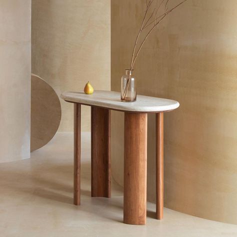 Add rich character and drama to any corner with our Trinsly console table. The bold and sculptural profile of our console table puts the beauty of natural materials on full display. The travertine top features rounded corners to accentuate the natural distress marks and earthy hues of the material. Its legs curve inwards to bring out the dramatic character of acacia wood. Set to make a bold and eye-catching impact, our console table makes a stunning statement in your lounge, bedroom, dining, or Console Drawing, Travertine Console Table, Dramatic Character, Curved Console, Corner Console, Travertine Colors, Rich Character, Console Table Entryway, Lounge Bedroom