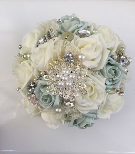 Mint green and ivory roses and brooch bouquet Quince Ramos Sage Green, Mint Green Quinceanera Decorations, Sage Green Ramos, Sage Green Quince Bouquet, Sage Green Quinceanera Ramo, Mint Green Quinceanera Theme, Mint Green Quince, Sage Quinceanera Theme, Light Green Quince