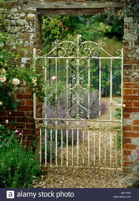 White painted metal garden gate in brick wall Stock Photo Garden Gate Decor, Tor Design, Wrought Iron Garden Gates, Old Gates, Garden Gates And Fencing, Metal Garden Gates, Iron Garden Gates, Garden Gate Design, Gates And Fences