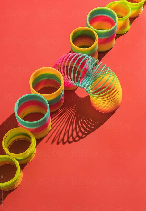 Colorful Slinky spring toy on colorful background. Slinky Toy, 80s Stuff, Figet Toys, Design Composition, Spiral Shape, Childhood Toys, Anime Drawings Tutorials, Stock Photography Free, Toys Photography